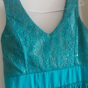 A beautiful Turquoise green dress, goes just below the knee.